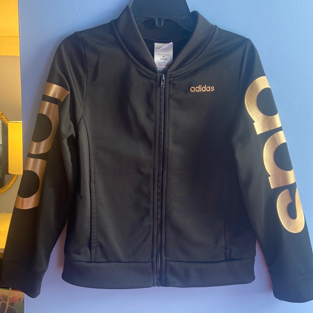 A jacket size 10/12 brand adidas it’s black with gold lettering on the sleeves